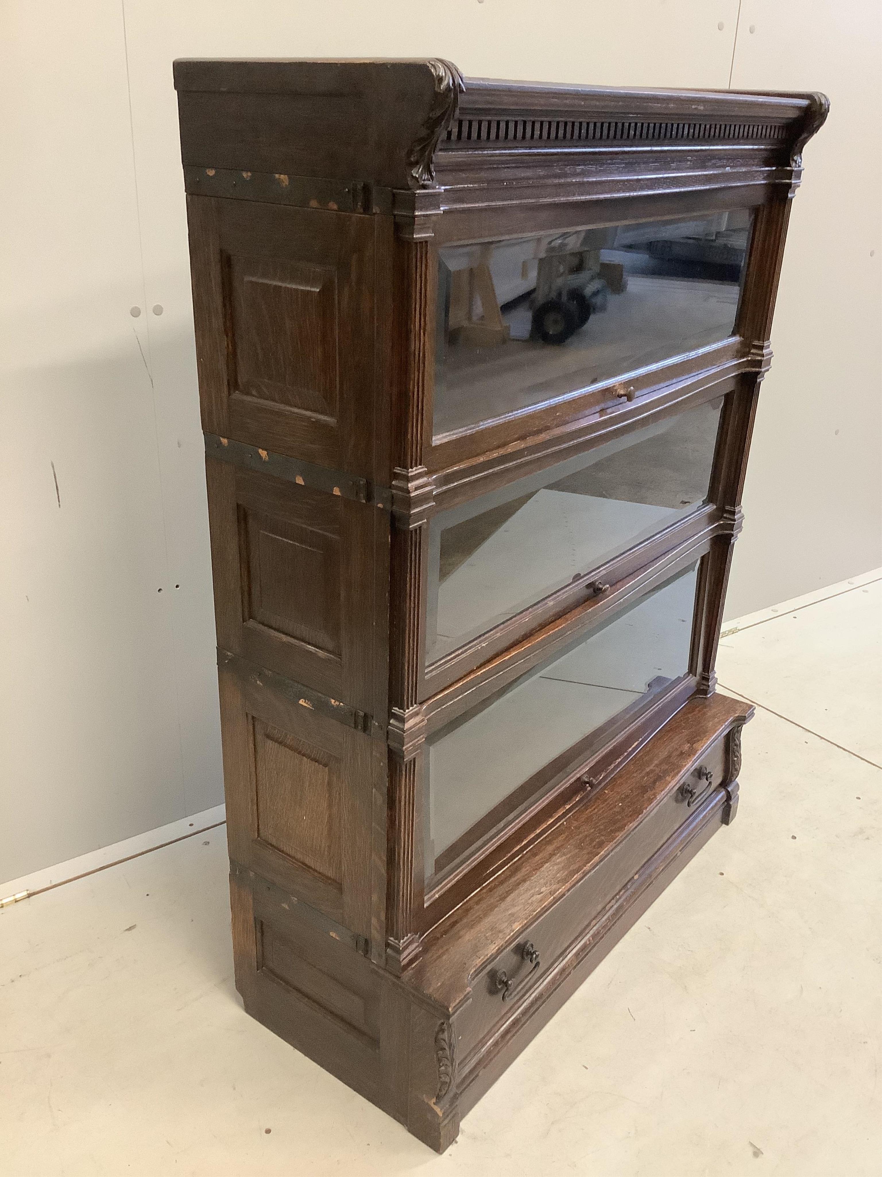 A Globe Wernicke oak three section bookcase, width 90cm, depth 38cm, height 121cm. Condition - fair